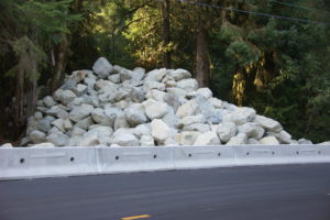 In preparation of further flash flooding coming down Dakota Creek, highways department build this massive retaining wall to re-direct high water back into the creek channel.